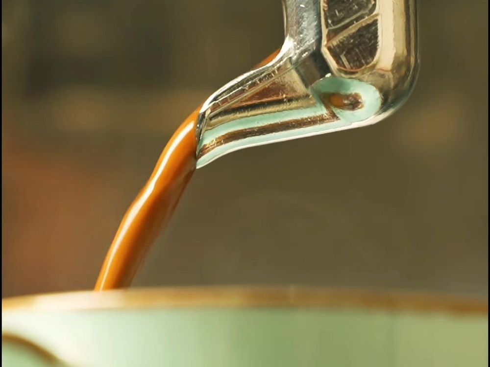 Espresso pouring from the machine into a cup at Wizzy Café