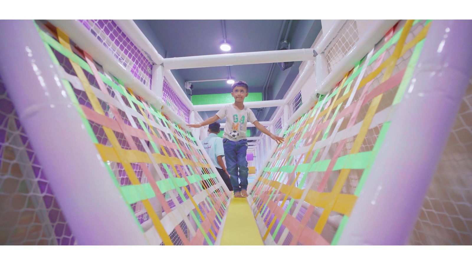 A child running through the netted rope maze