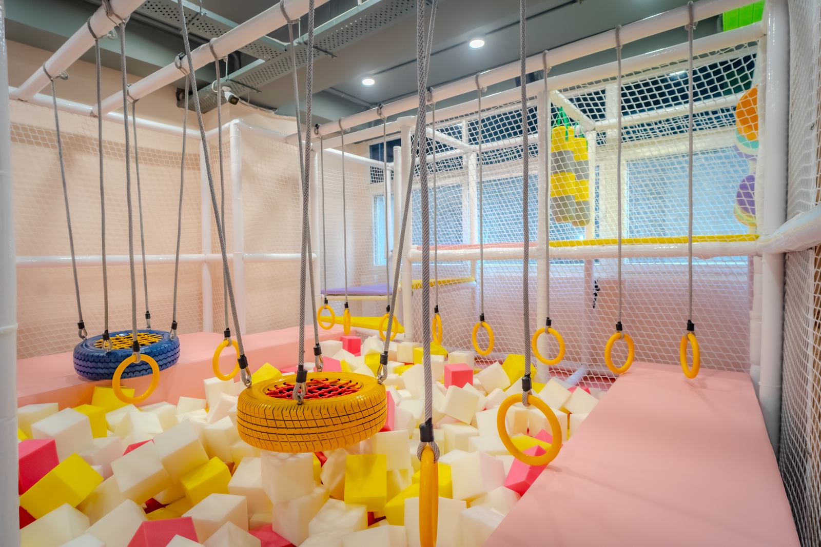 Foam cube pit with gymnastic rings and tyre swings